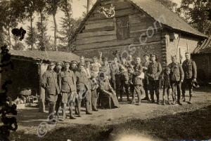 Group of soldiers in a farmyard with woman and thr