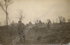 Soldier standing on the outskirts of a village.  1