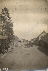 Horse-drawn transport moving through village. 1/4t