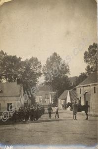 Soldiers waiting in a village street. 1/4th Battal