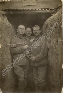 Three soldiers standing outside signallers' dugout