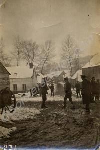 Soldiers in a snowy and muddy village. 1/4th Batta