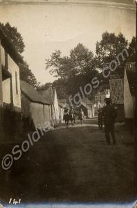 Soldiers in a village street. 1/4th Battalion, The
