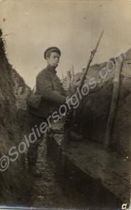 Soldier with rifle and fixed bayonet in a trench.