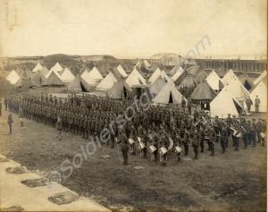 Parade and band outside encampment. 1st Battalion,