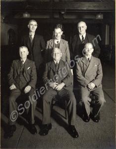 Informal group of men in civilian clothes. Possibl