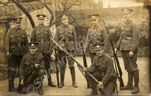 Seven soldiers with rifles and fixed bayonets, uni