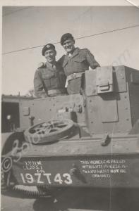 Two soldiers standing in a Bren gun carrier. Rever