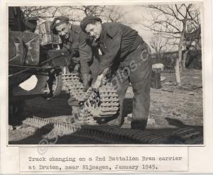 Two soldiers changing a track. Typed front 'Track