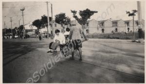 'Girls getting a ride on a wheel barrow'.  2nd Bat