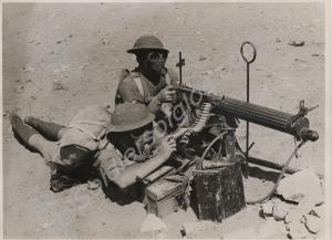 Two soldiers wearing gas masks with Vickers machin