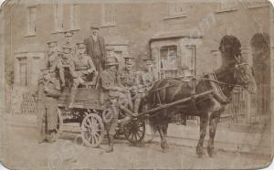 Soldiers and civilians, on horse-drawn cart belong