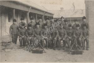Group of soldiers in fur-lined caps, with two trip