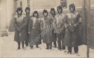 Group of soldiers in fur-lined caps, standing in s
