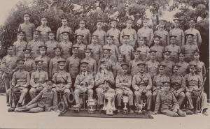 Soldiers with collection of silver trophies.  2nd