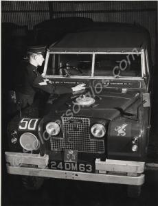Corporal Reade of 'HQ' Company affixing plastic Ba
