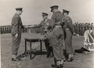 Major W.O.V. Clee receiving the Coronation Medal f