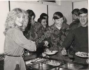 Beauty Queen "Miss Avon" in cookhouse with a group