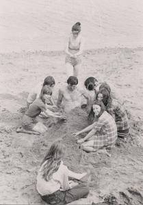 Corporal Hoare with children at the beach. 1st Bat