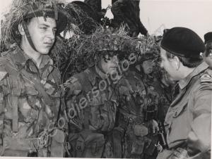 Inspection of camouflaged troops by a Lieutenant C