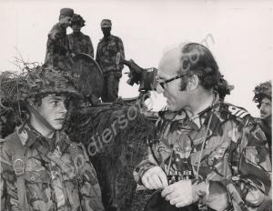 Inspection of camouflaged troops by a Lieutenant C
