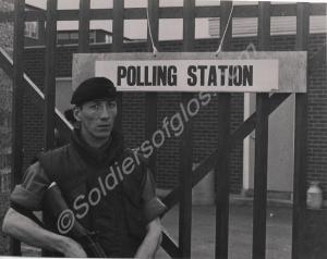 Private Peter Milne standing by a Polling Station.