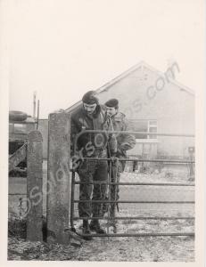 Two soldiers in a farm yard. 1st Battalion, The Gl