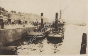 Ships in harbour with ambulances at quayside. 1914