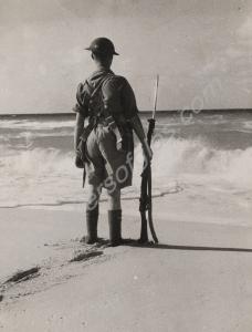 Soldier standing at ease  on the beach.  2nd Batta