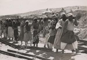Egyptian construction gang laying railway track be