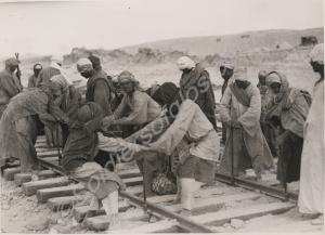 Egyptian construction gang laying railway track be