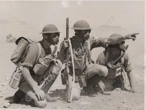 Soldiers of "D" Company with gas masks on desert e