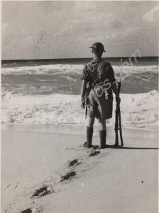 Soldier standing at ease  on the beach.  2nd Batta