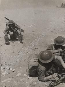 Soldier in gas mask bringing ammunition boxes for