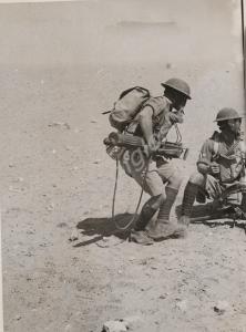 Soldiers in gas masks assembling Vickers machine g