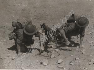 Soldiers in gas masks positioning Vickers machine