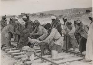 Egyptian construction gang laying rail track betwe