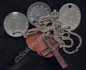Five identity tags and a crucifix. Belonging to 35