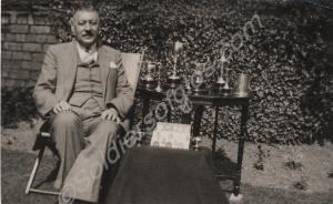 Lieutenant F.W. Saunders with shooting trophies, 1