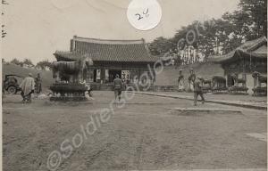 HQ showing vehicle and Korean buildings. 1st Batta