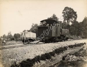 Narrow gauge railway engine taking on water at the