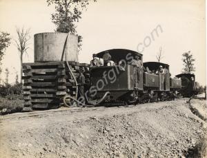 Narrow gauge railway engines taking on water. Belg