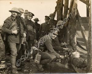 Troops filling water bottles at a watering point.