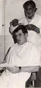 Regimental Sergeant Major Lambey having a haircut.
