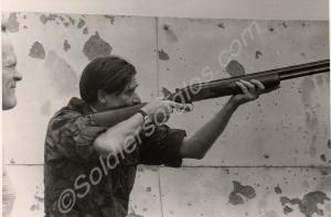 Lieutenant-Colonel Simon Firth aiming shotgun. Glo