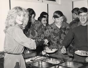 Beauty Queen, "Miss Avon" serving food in the cook