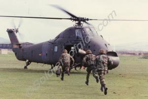 Soldiers running to board a helicopter, Northern I