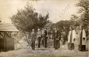 Clerics and service personnel by a church lychgate