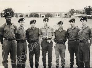 Group of soldiers, one holding a trophy. Glouceste