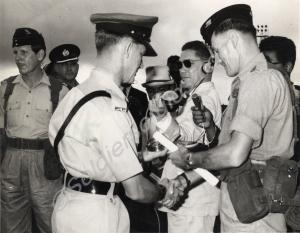 Company Sergeant-Major Ivor Dee (on right) swaps s